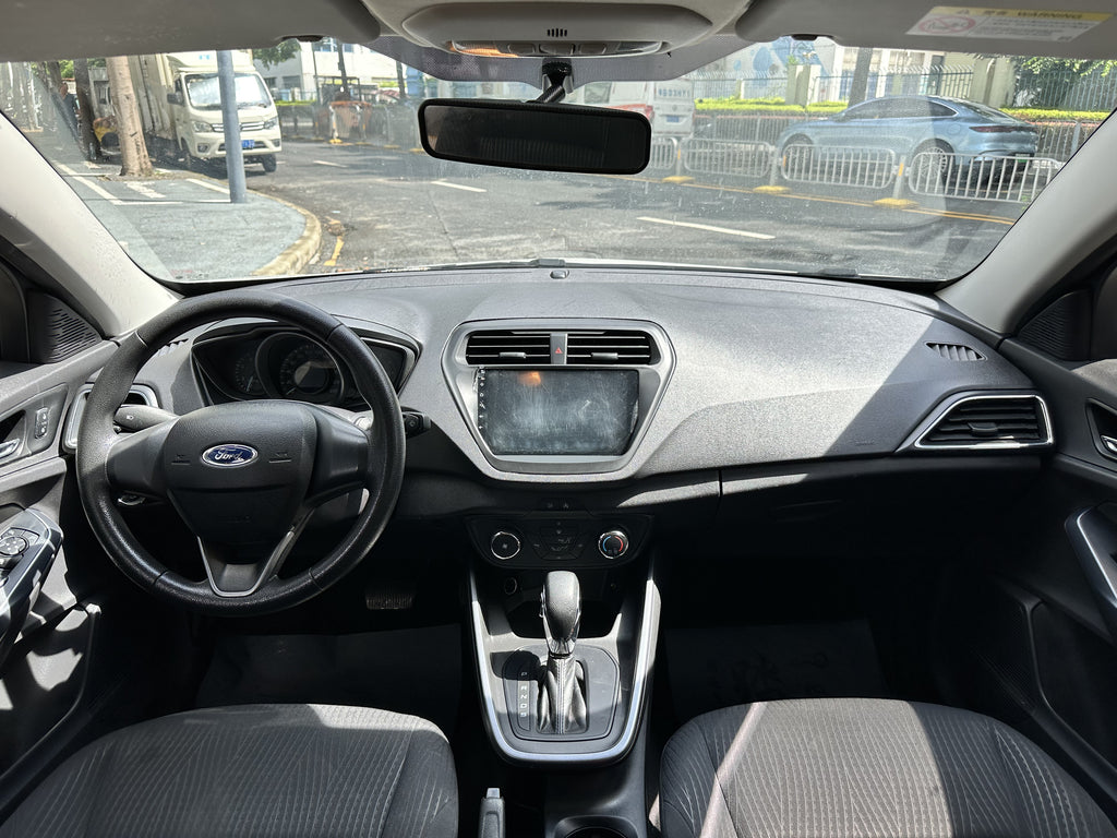 Used 2019 Ford Focus white sedan rear three-quarter view 2