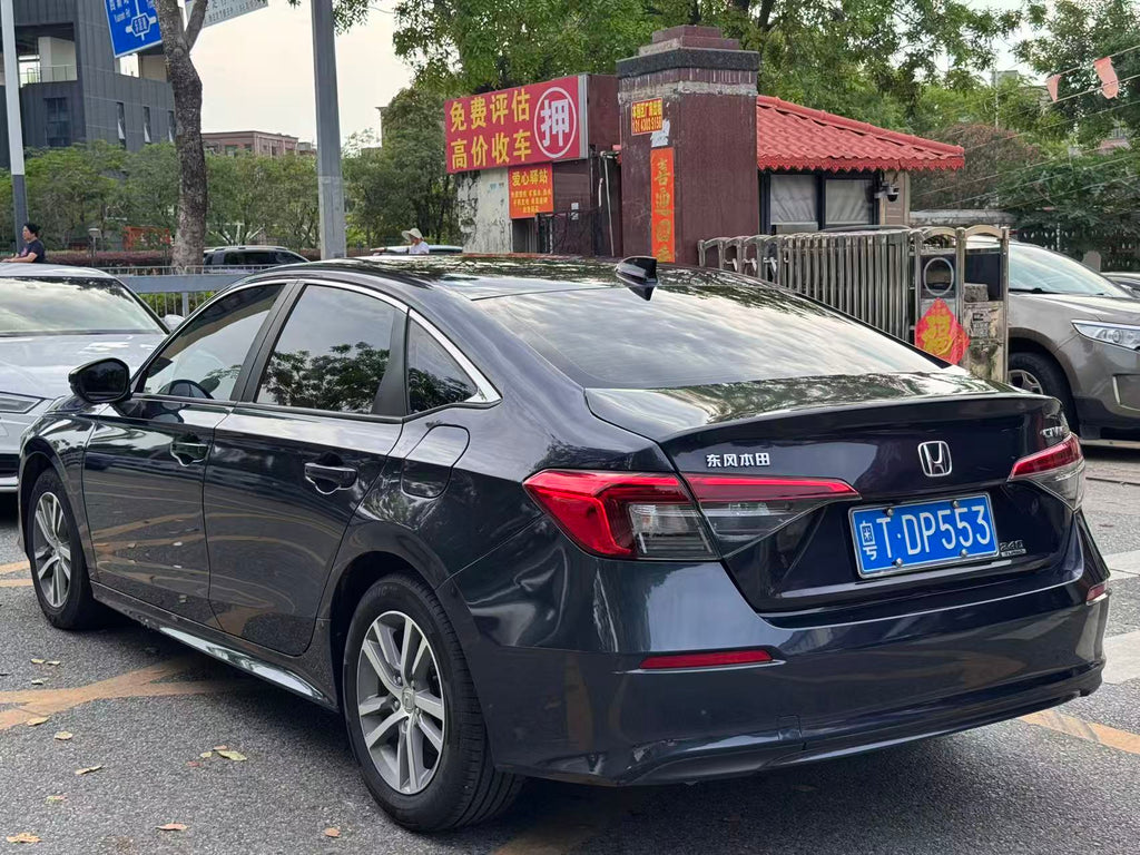 Honda Civic 2023 rear three-quarter view - blue