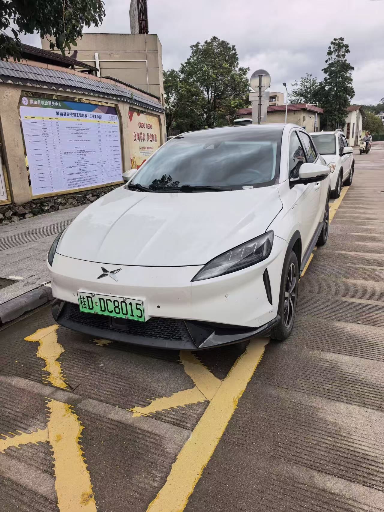 Xpeng G3 white exterior front view with green EV license plate