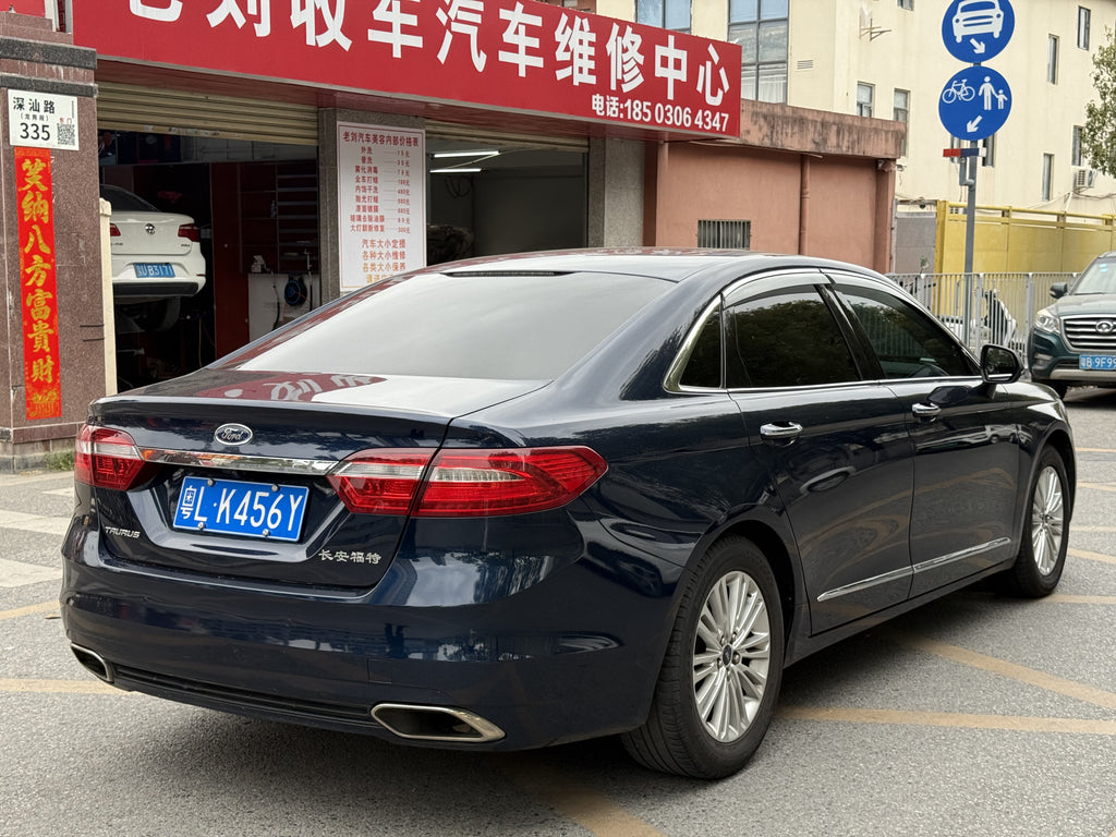 2015 Ford Taurus EcoBoost 245 - Front 3/4 view, Sapphire Blue