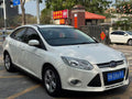 Ford Focus 2012 front three-quarter view - white compact sedan