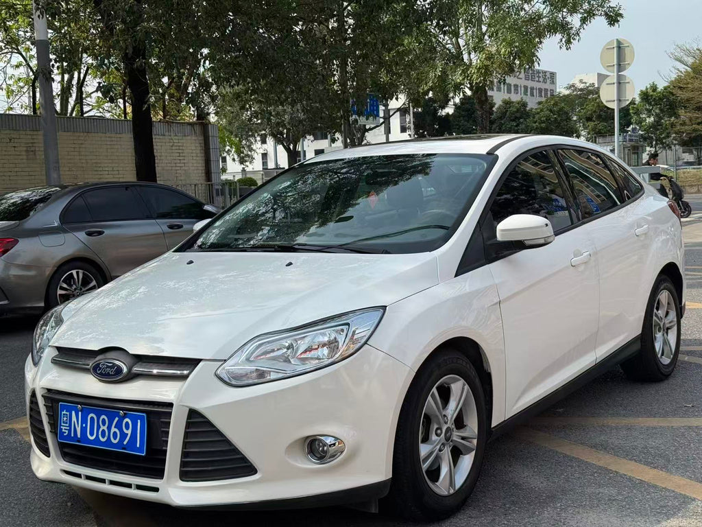 Ford Focus 2012 side rear view - white sedan exterior